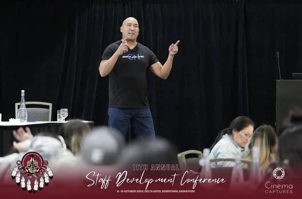 Carlin speaking on stage — Overcoming Adversity